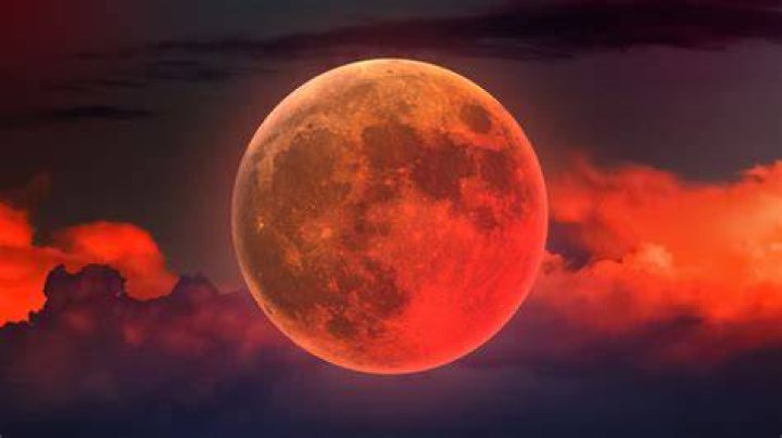 The full moon shines red behind a high tension wire near Jacobsdorf, Germany, 20 June 2016. The arriving night was the shortest of the year. The late setting sun colored the full moon red. The natural phenomenon is called 'strawberry moon.' Photo by: Patrick Pleul/picture-alliance/dpa/AP Images